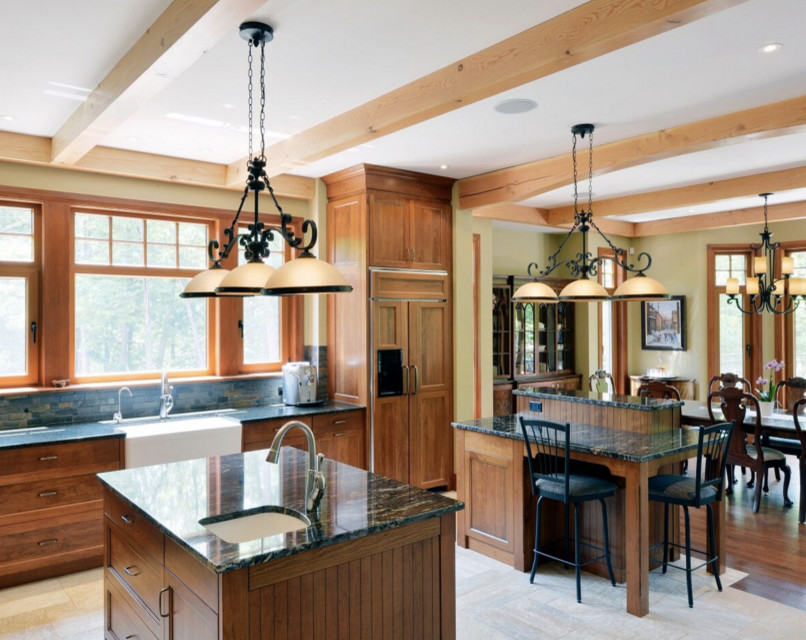 Inspiration for a large rustic galley dark wood floor open concept kitchen remodel in Boston with an undermount sink, shaker cabinets, white cabinets, granite countertops, stainless steel appliances and an island