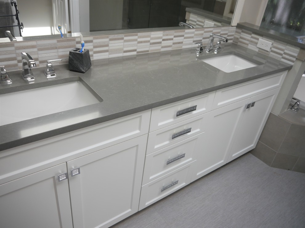Photo of a large transitional master bathroom in Seattle with shaker cabinets, white cabinets, a drop-in tub, gray tile, porcelain tile, grey walls, linoleum floors, an undermount sink, engineered quartz benchtops, grey floor, a hinged shower door and grey benchtops.