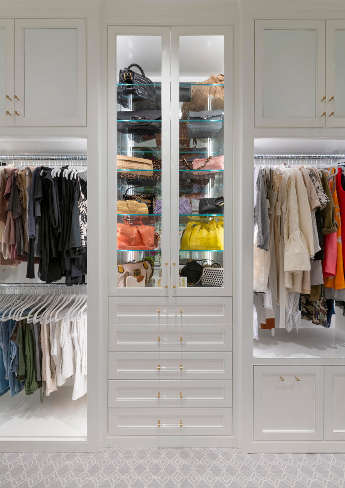 This is an example of a medium sized traditional gender neutral walk-in wardrobe in Dallas with beaded cabinets, white cabinets, carpet and grey floors.