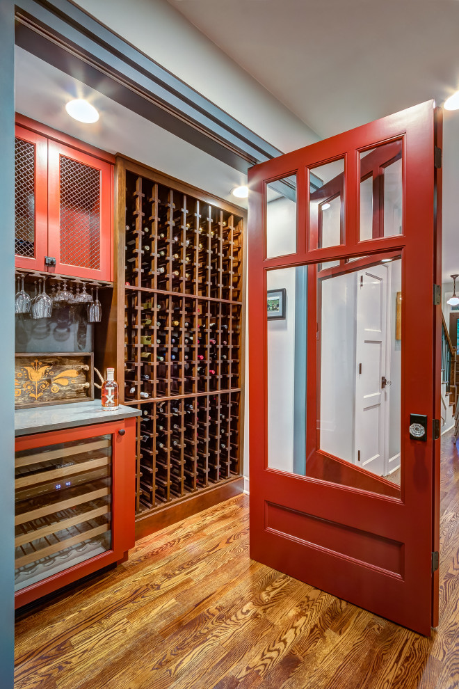 Inspiration for a small eclectic wine cellar in Houston with dark hardwood floors and brown floor.