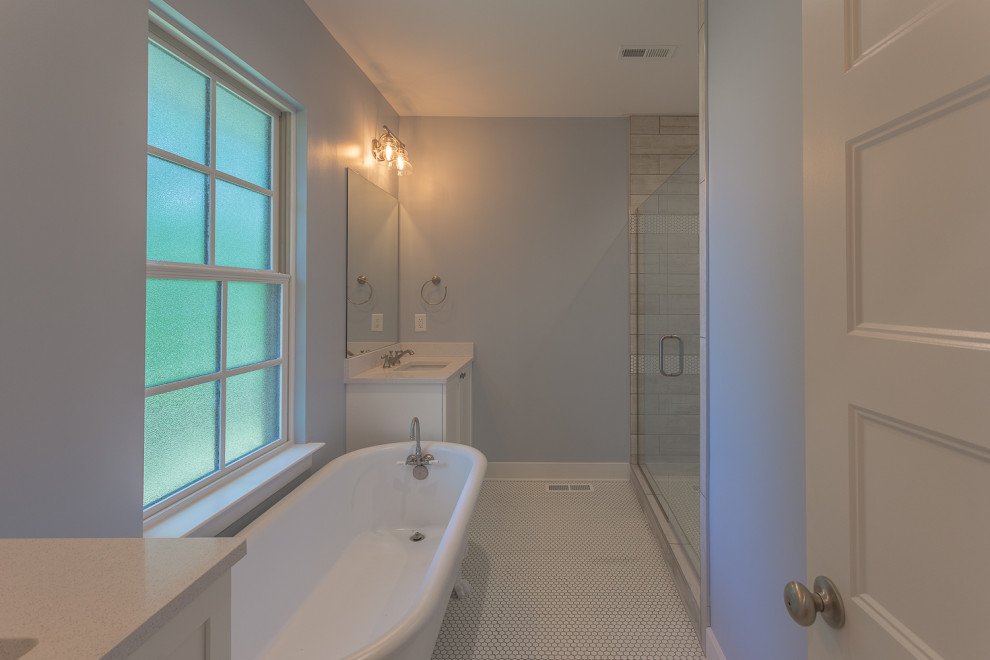This is an example of a mid-sized country master bathroom in Other with beaded inset cabinets, white cabinets, a claw-foot tub, an open shower, a two-piece toilet, white tile, wood-look tile, blue walls, mosaic tile floors, an undermount sink, engineered quartz benchtops, white floor, a hinged shower door, white benchtops, an enclosed toilet, a double vanity and a built-in vanity.
