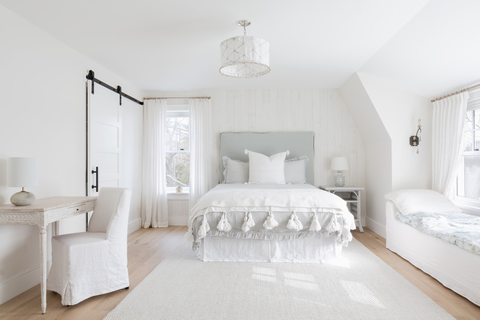 Beach style bedroom in Boston with white walls, light hardwood floors and beige floor.