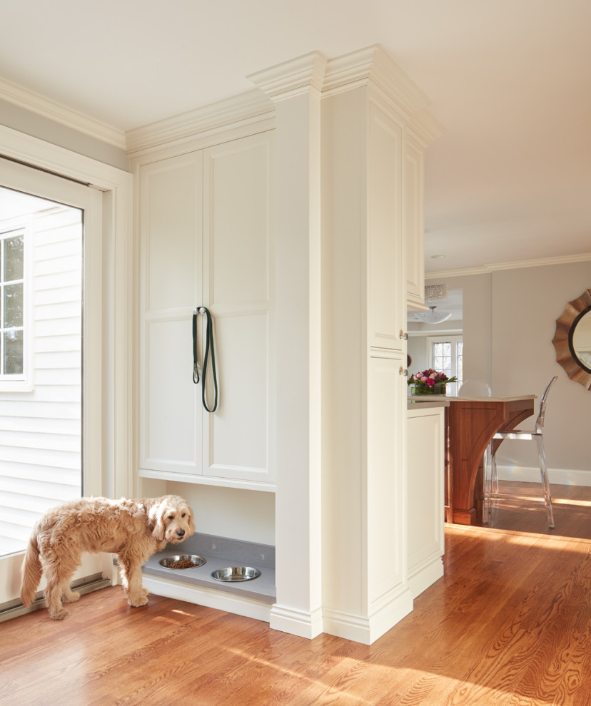 Open concept kitchen - large traditional l-shaped medium tone wood floor open concept kitchen idea with beaded inset cabinets, white cabinets, quartz countertops, stainless steel appliances and an island