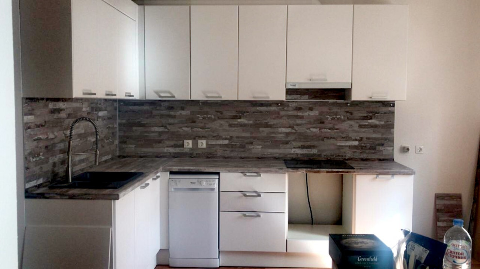 Mid-sized scandinavian l-shaped separate kitchen in Yekaterinburg with a double-bowl sink, flat-panel cabinets, white cabinets, laminate benchtops, multi-coloured splashback, black appliances and pink benchtop.