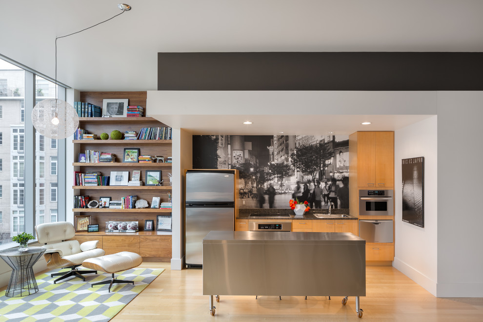 Photo of a small contemporary single-wall open plan kitchen in Portland with flat-panel cabinets, medium wood cabinets, stainless steel appliances, light hardwood floors and with island.