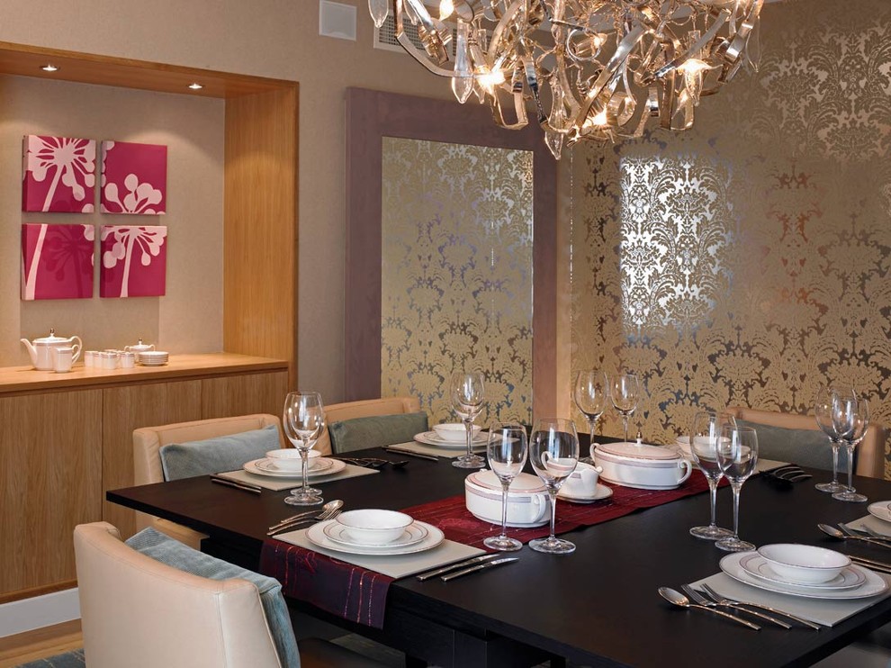 This is an example of a contemporary dining room in London with beige walls and dark hardwood floors.