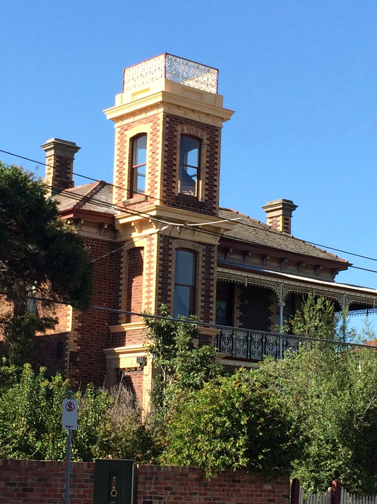 Inspiration for a large traditional two-storey brick brown exterior in Melbourne with a gable roof.