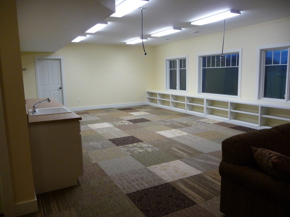 Large transitional look-out carpeted basement photo with yellow walls