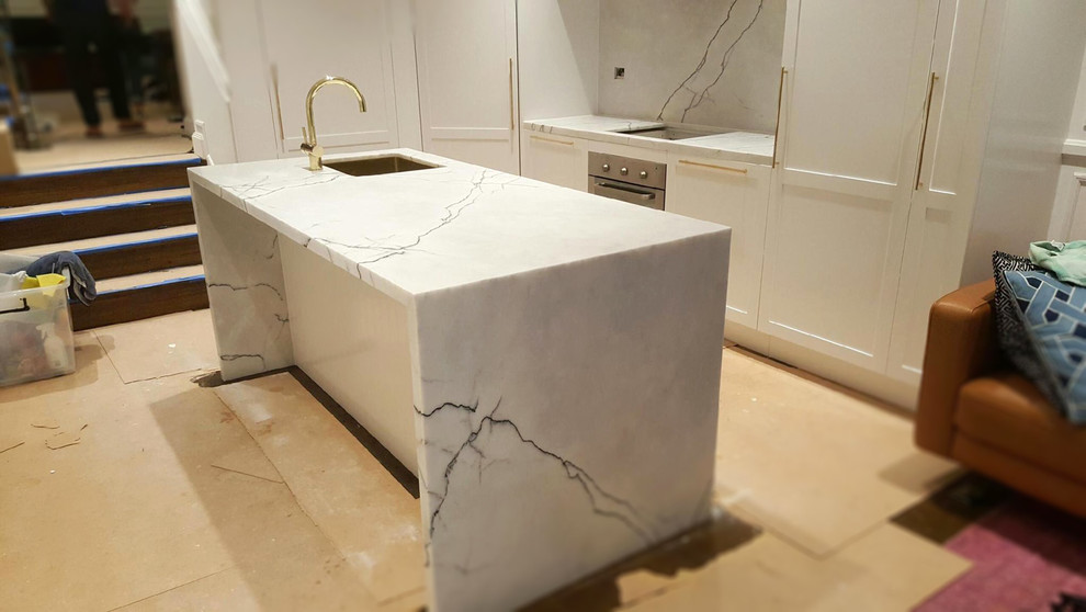 Inspiration for a contemporary kitchen in Sydney with marble benchtops, white splashback, stone slab splashback and with island.