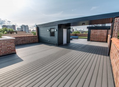 Huge minimalist rooftop deck photo in Chicago with a roof extension