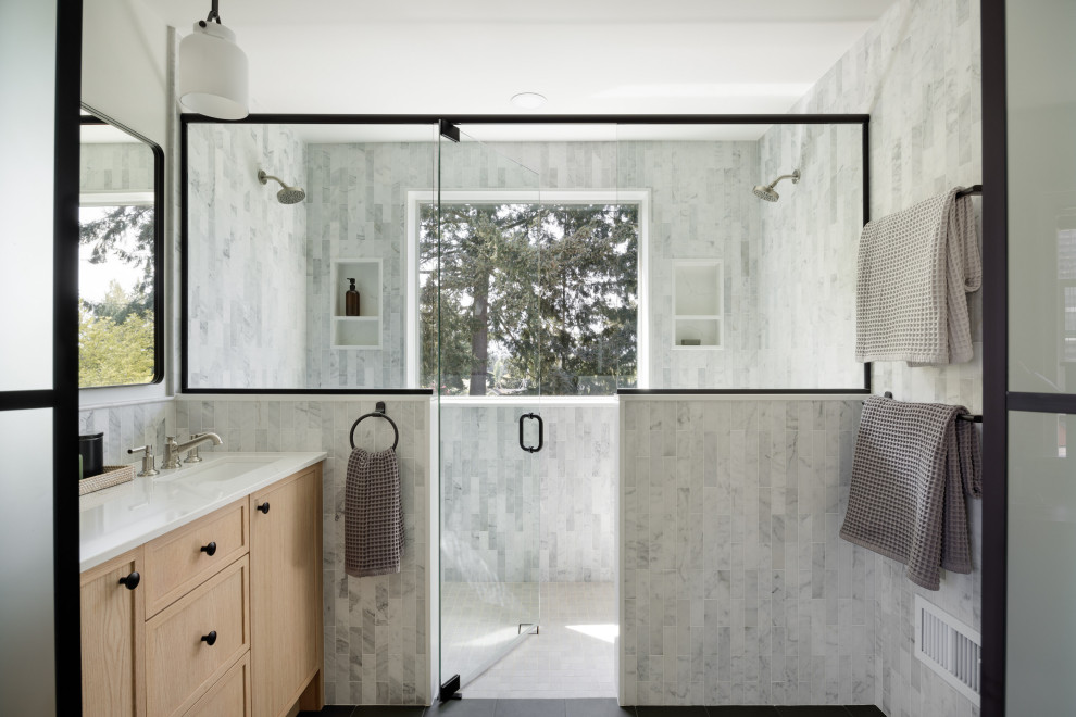Inspiration for a transitional master gray tile and white tile gray floor and single-sink double shower remodel in Seattle with shaker cabinets, light wood cabinets, an undermount sink, marble countertops, a hinged shower door, white countertops and a built-in vanity