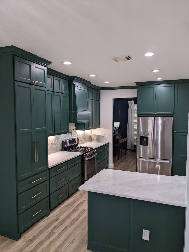Transitional kitchen photo in Houston with a farmhouse sink, shaker cabinets, green cabinets, quartz countertops, white backsplash, ceramic backsplash, stainless steel appliances and white countertops