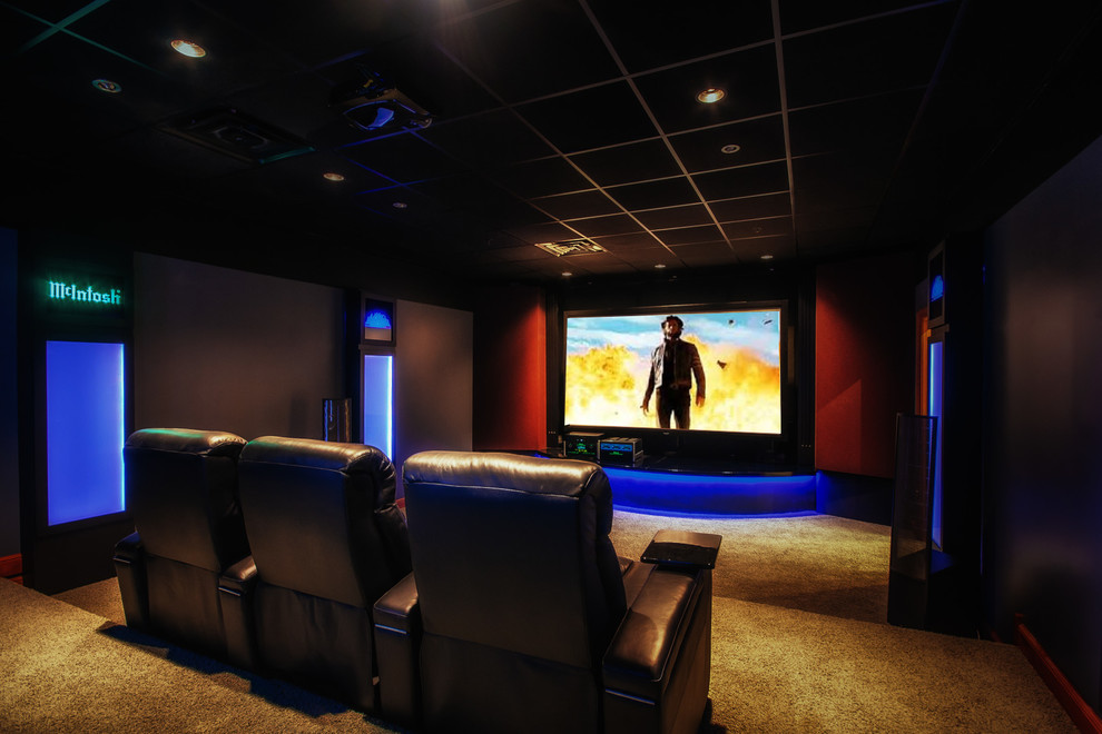Inspiration for a mid-sized traditional enclosed home theatre in Chicago with black walls, carpet and a projector screen.