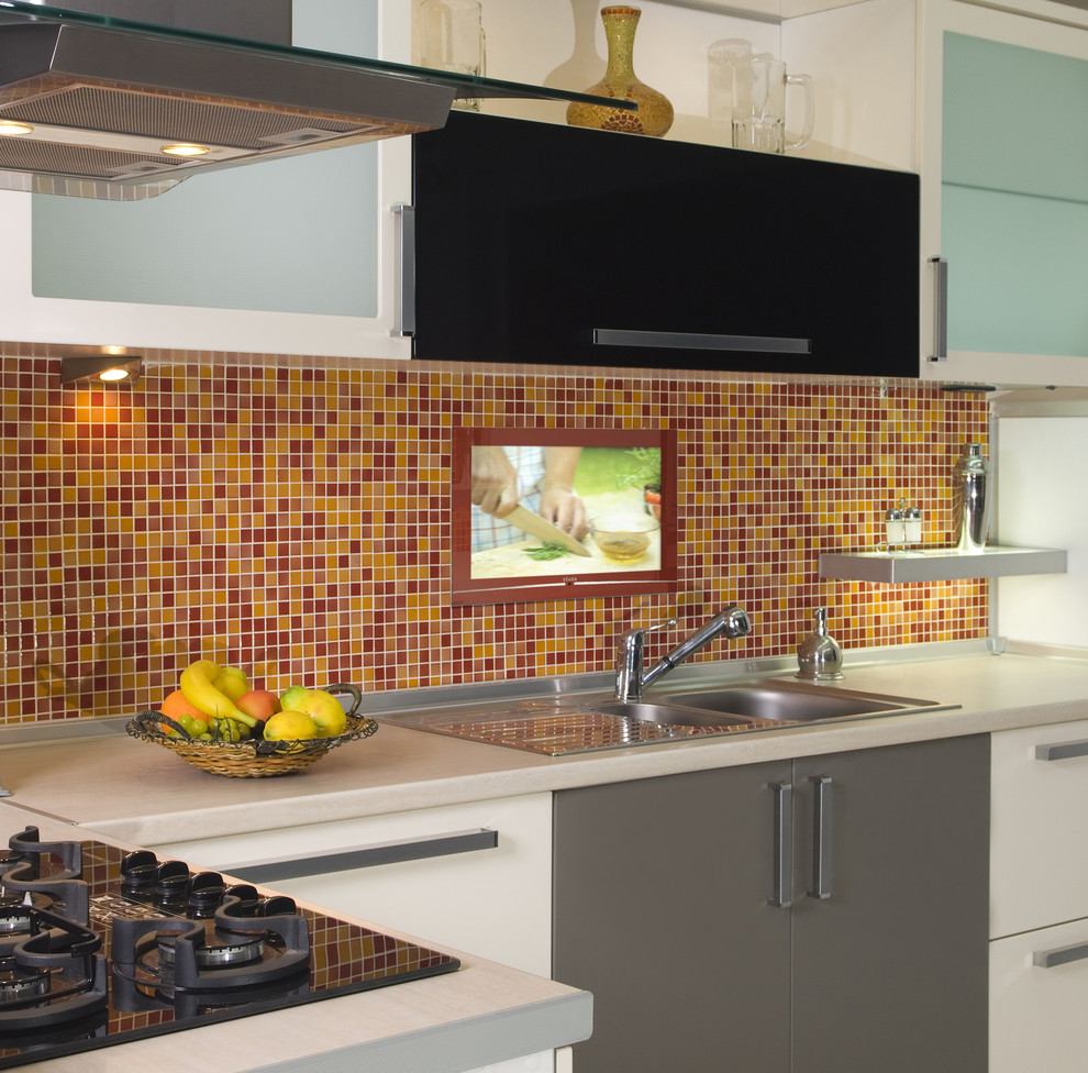 Contemporary kitchen in Other with a drop-in sink, flat-panel cabinets, white cabinets, multi-coloured splashback, mosaic tile splashback and black appliances.