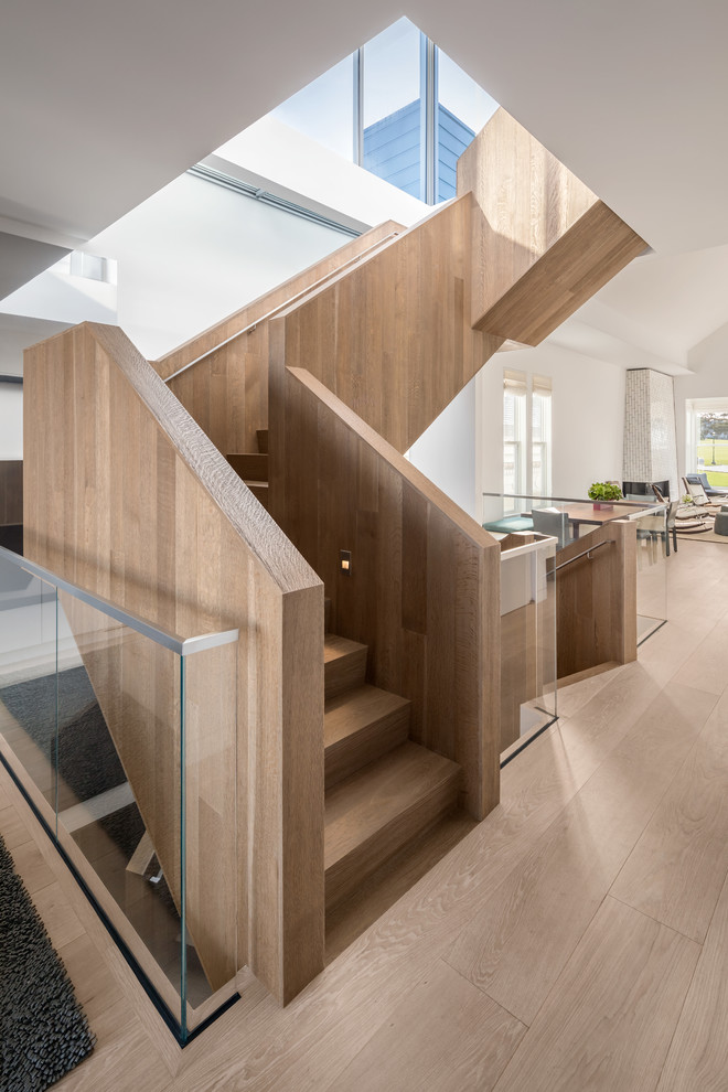 Inspiration for a large contemporary wood u-shaped staircase in San Francisco with wood risers and wood railing.