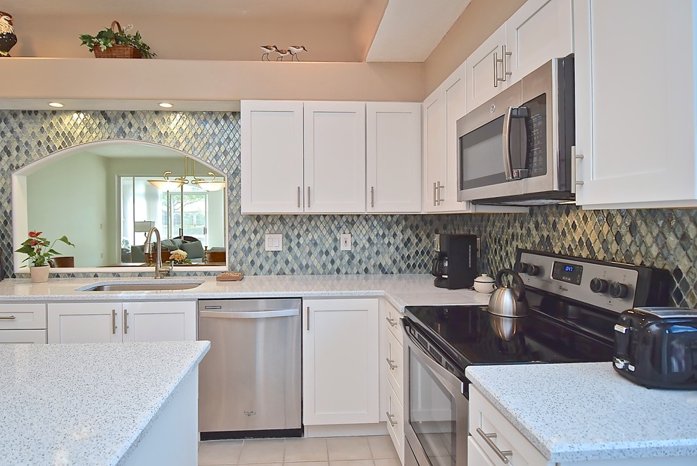 Mid-sized transitional eat-in kitchen in Tampa with an undermount sink, recessed-panel cabinets, white cabinets, recycled glass benchtops, blue splashback, glass tile splashback, stainless steel appliances, with island and yellow benchtop.