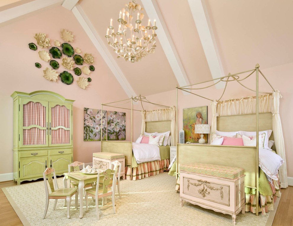 Photo of a traditional kids' bedroom for kids 4-10 years old and girls in Dallas with pink walls and light hardwood floors.