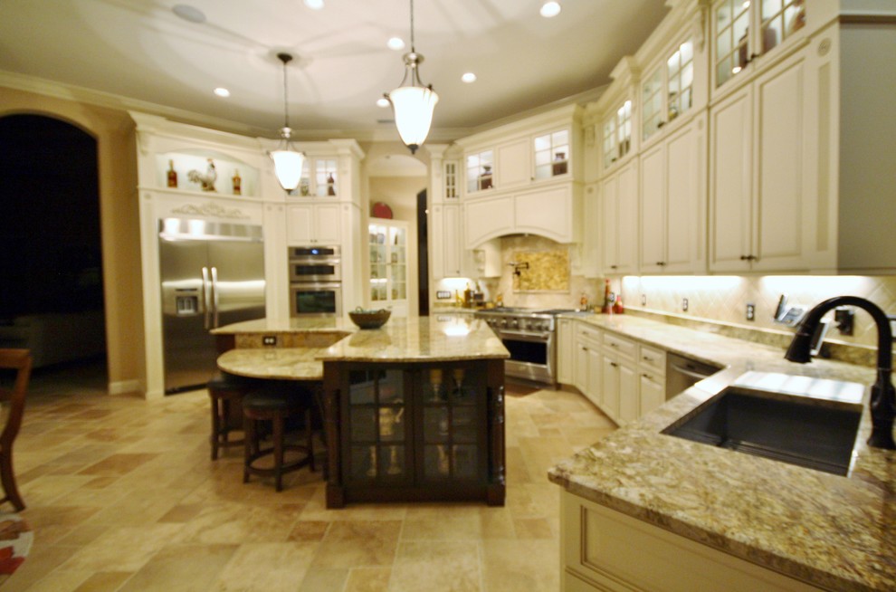 Inspiration for a large transitional u-shaped porcelain tile eat-in kitchen remodel with raised-panel cabinets, white cabinets, granite countertops, stainless steel appliances, an island, an undermount sink and beige backsplash