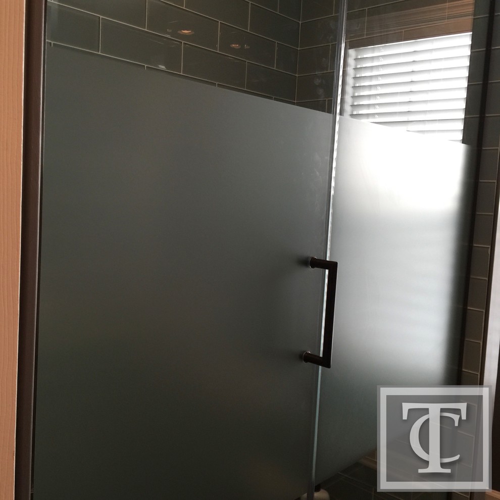 Photo of a mid-sized eclectic kids bathroom in Baltimore with recessed-panel cabinets, medium wood cabinets, a double shower, a two-piece toilet, green tile, glass tile, grey walls, ceramic floors, a trough sink and soapstone benchtops.