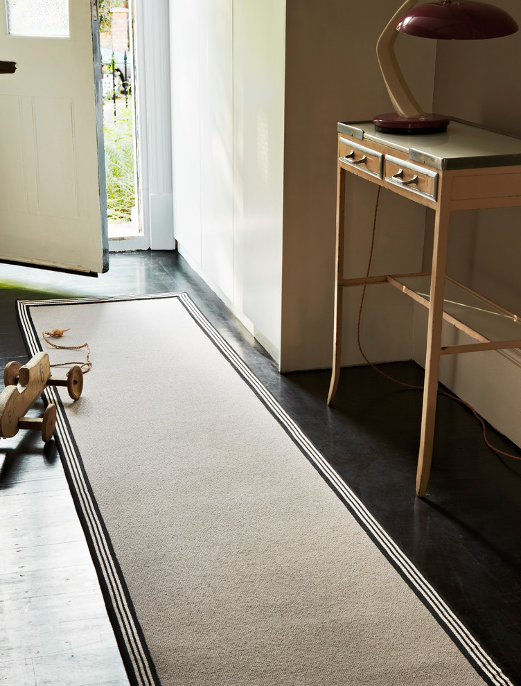 Photo of a contemporary hallway in Hampshire with carpet and black floor.