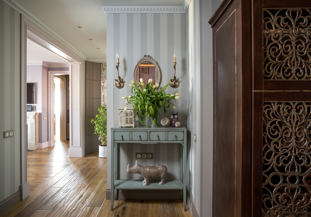 This is an example of a traditional hallway in Moscow with grey walls and medium hardwood floors.