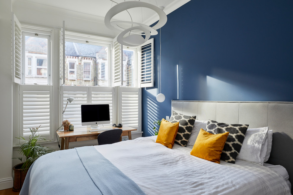 Свежая идея для дизайна: маленькая хозяйская спальня в стиле неоклассика (современная классика) с синими стенами, паркетным полом среднего тона, коричневым полом и акцентной стеной для на участке и в саду - отличное фото интерьера