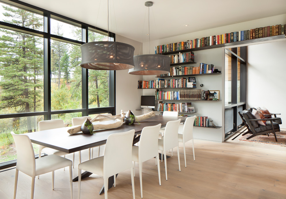 Contemporary dining room in Other with white walls, medium hardwood floors and brown floor.