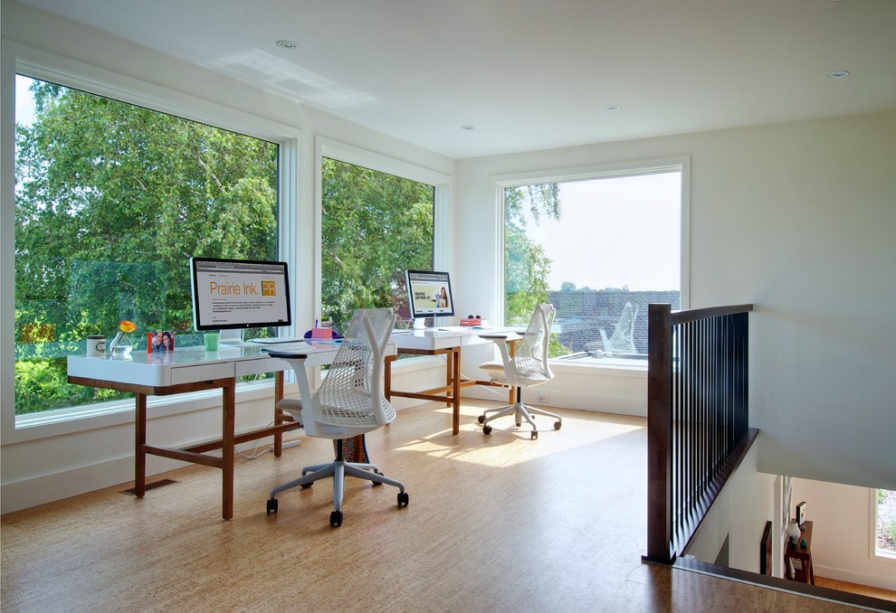 Photo of a contemporary home office in Toronto with white walls and a freestanding desk.