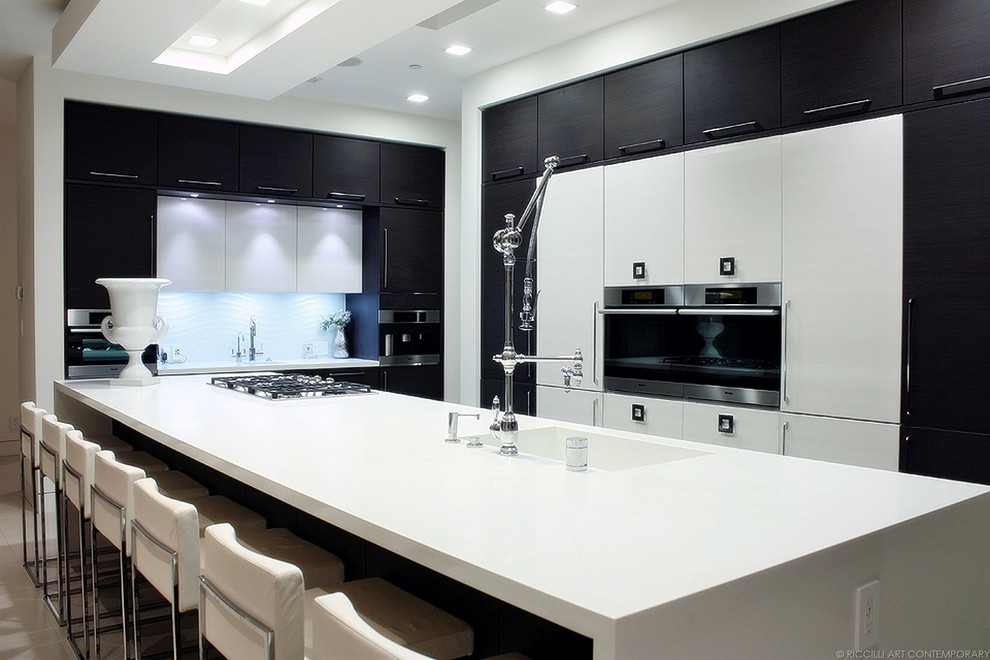Photo of a contemporary galley open plan kitchen in San Francisco with an integrated sink, flat-panel cabinets, white cabinets, quartz benchtops and with island.