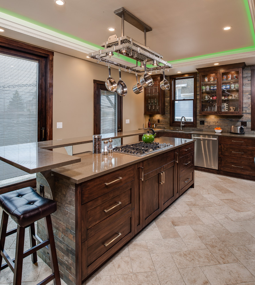 Example of a mid-sized transitional l-shaped travertine floor eat-in kitchen design with an undermount sink, recessed-panel cabinets, dark wood cabinets, quartz countertops, multicolored backsplash, stone slab backsplash, stainless steel appliances and an island