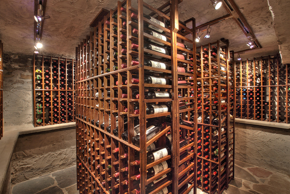 Inspiration for an expansive traditional wine cellar in New York with slate floors and storage racks.