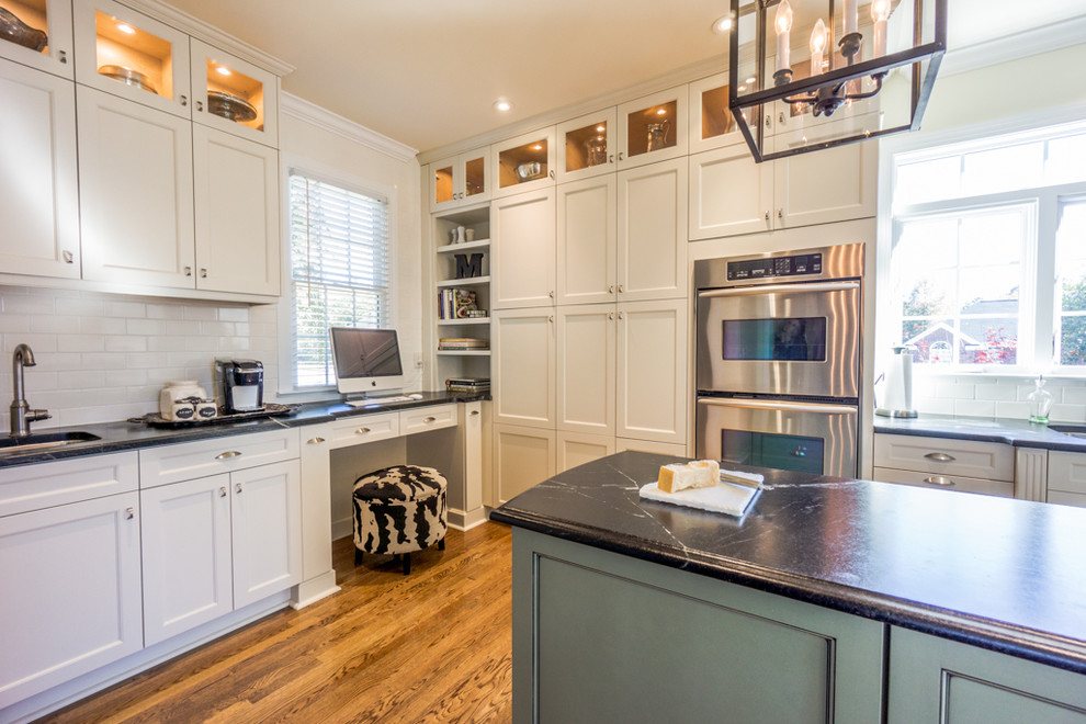 Photo of a transitional kitchen in Raleigh with an undermount sink, shaker cabinets, white cabinets, white splashback, subway tile splashback and stainless steel appliances.