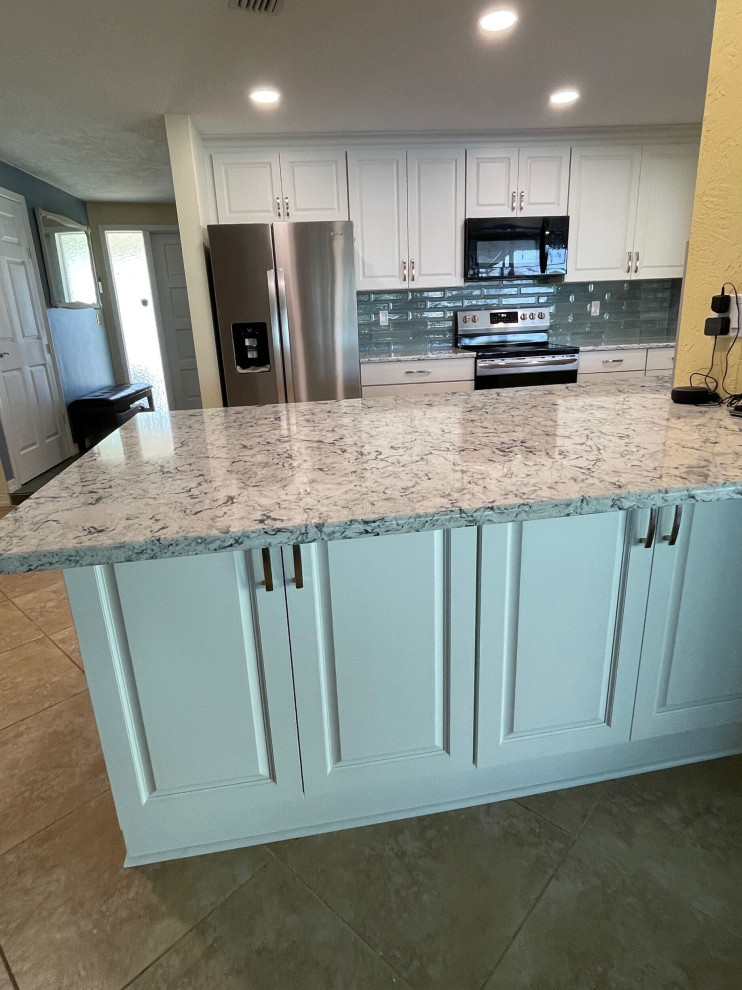 Photo of a mid-sized transitional eat-in kitchen in Tampa with shaker cabinets, white cabinets, quartz benchtops, blue splashback and ceramic splashback.
