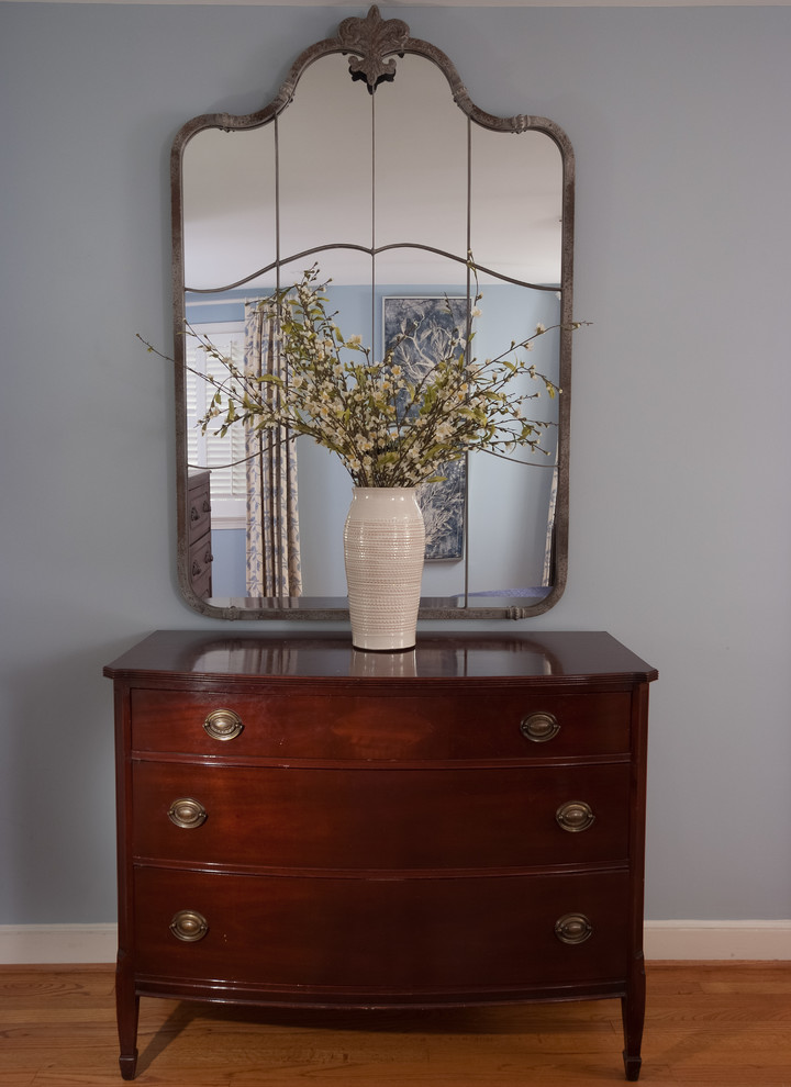 Mid-sized transitional master light wood floor and brown floor bedroom photo with blue walls