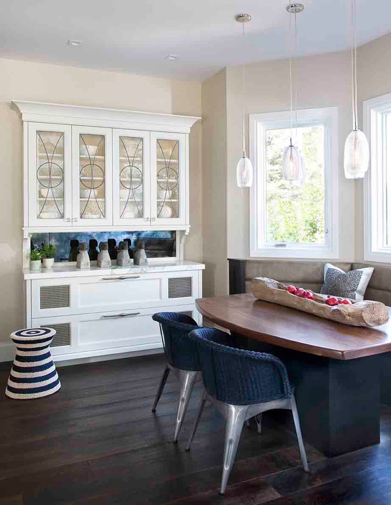 Photo of a transitional dining room in Other with beige walls and dark hardwood floors.