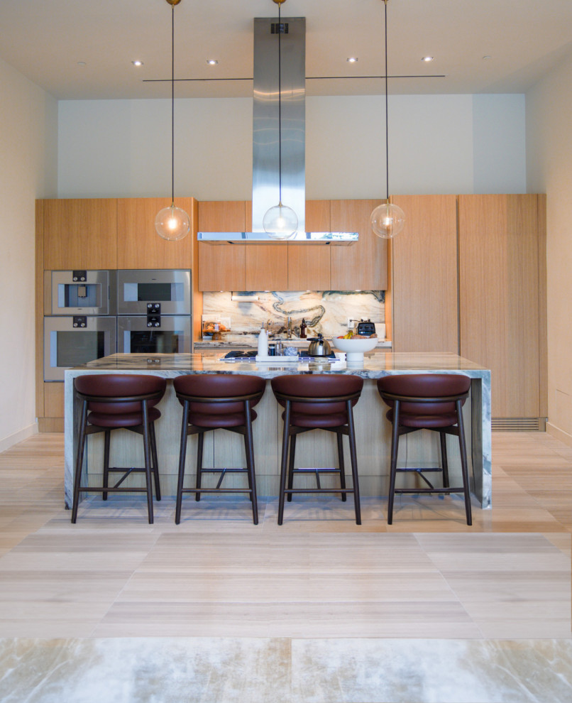 This is an example of a contemporary galley open plan kitchen in Miami with flat-panel cabinets and an island.