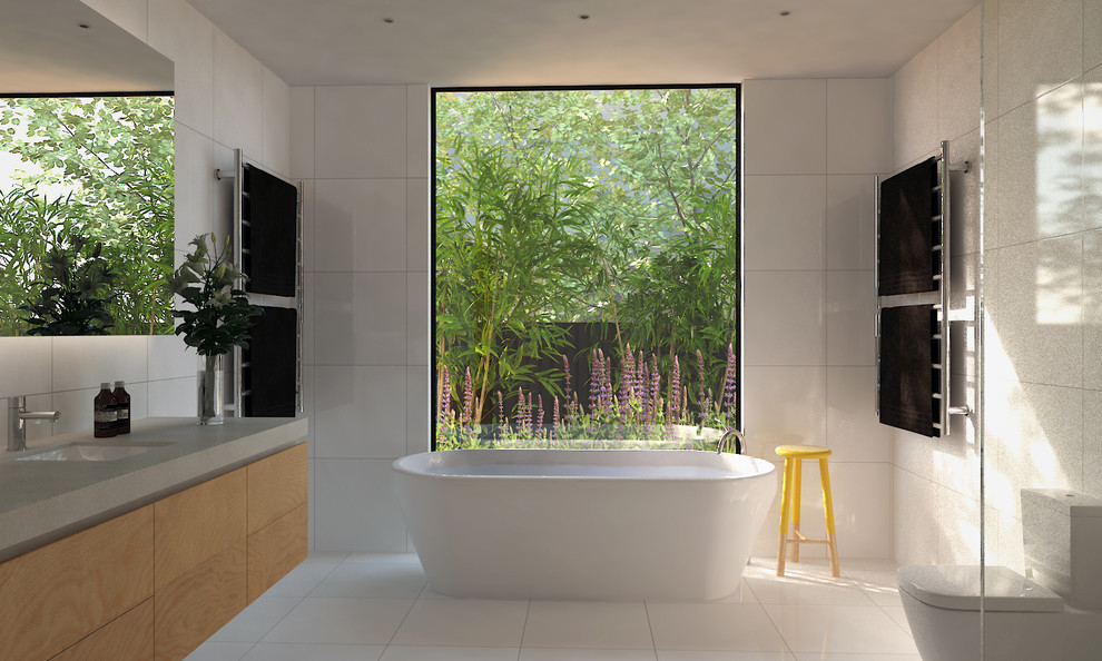 Inspiration for a mid-sized contemporary bathroom in Melbourne with an undermount sink, flat-panel cabinets, light wood cabinets, engineered quartz benchtops, a freestanding tub, an open shower, a one-piece toilet and white tile.