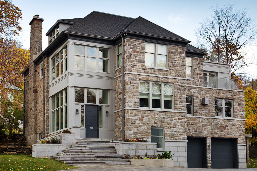 This is an example of a large transitional three-storey grey house exterior in Montreal with mixed siding, a clipped gable roof and a shingle roof.