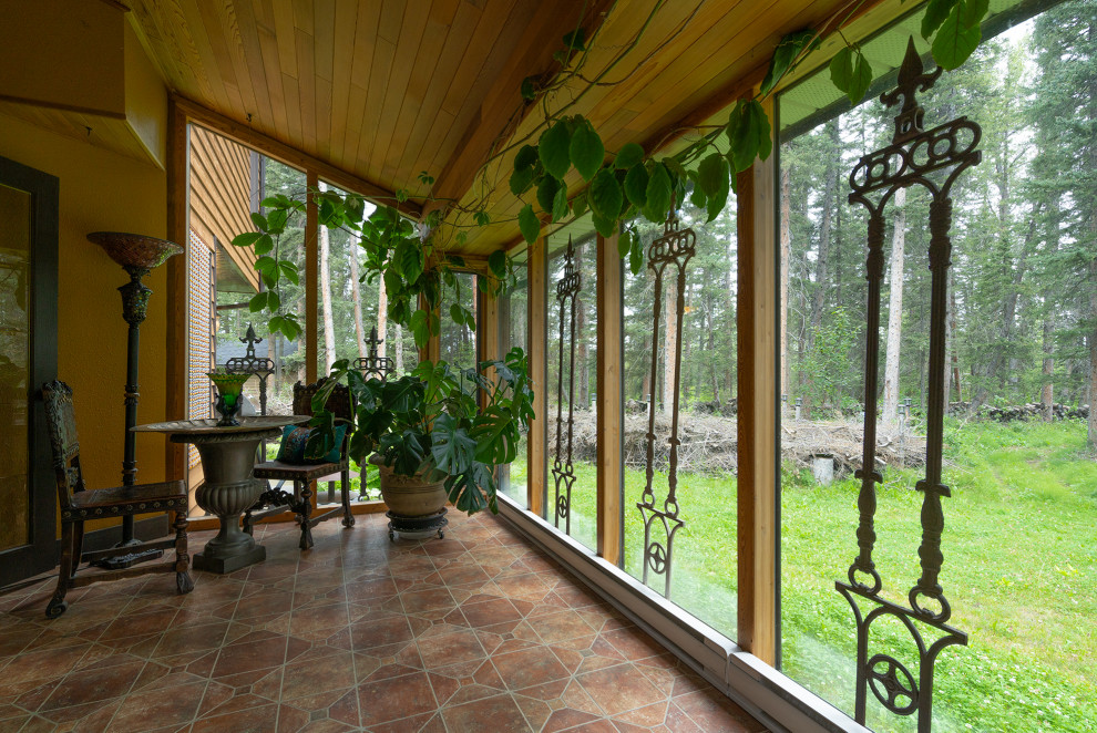 Design ideas for a mid-sized traditional sunroom in Calgary with terra-cotta floors, a standard ceiling and orange floor.