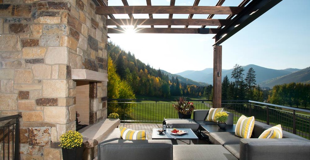 Photo of a large modern deck in Denver with a fire feature and a pergola.