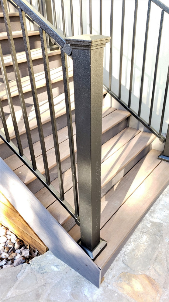 Inspiration for a large rustic backyard second story metal railing staircase remodel in Austin with a roof extension