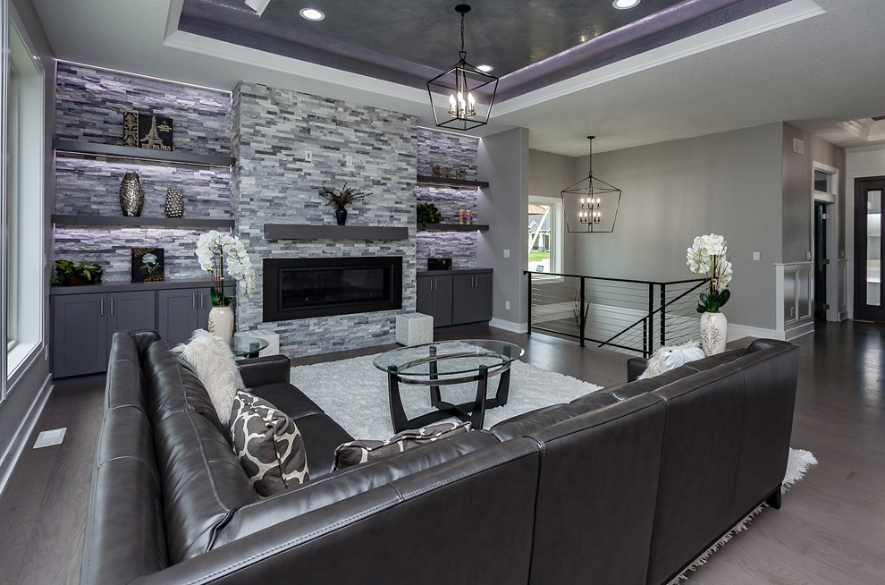 Large transitional open concept living room in Other with grey walls and grey floor.