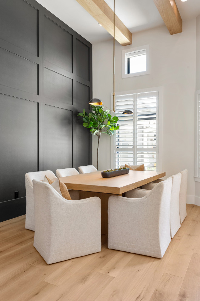 Dining room - transitional light wood floor, beige floor and wall paneling dining room idea in Austin with white walls