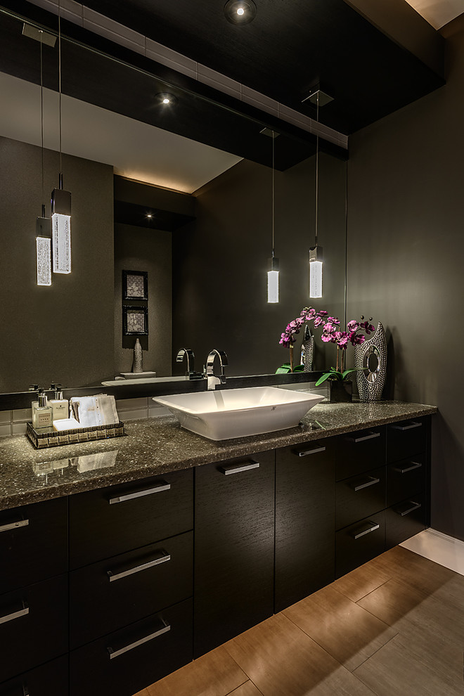 This is an example of a contemporary powder room in Vancouver with a vessel sink and grey benchtops.