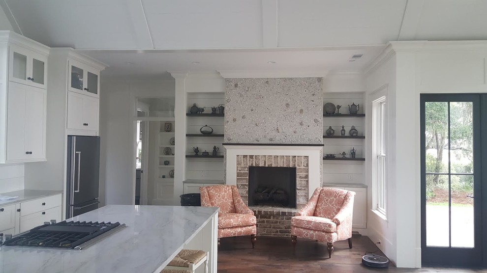 Inspiration for a mid-sized beach style formal and open concept medium tone wood floor living room remodel in San Diego with white walls, a standard fireplace, a brick fireplace and no tv
