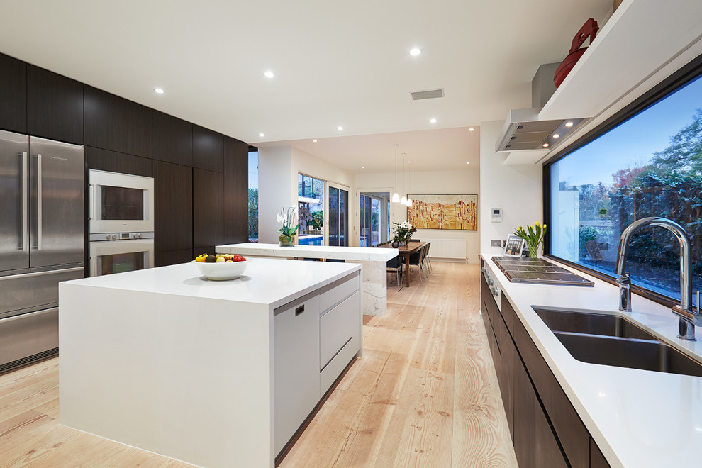 Inspiration for a modern eat-in kitchen in Melbourne with dark wood cabinets and multiple islands.