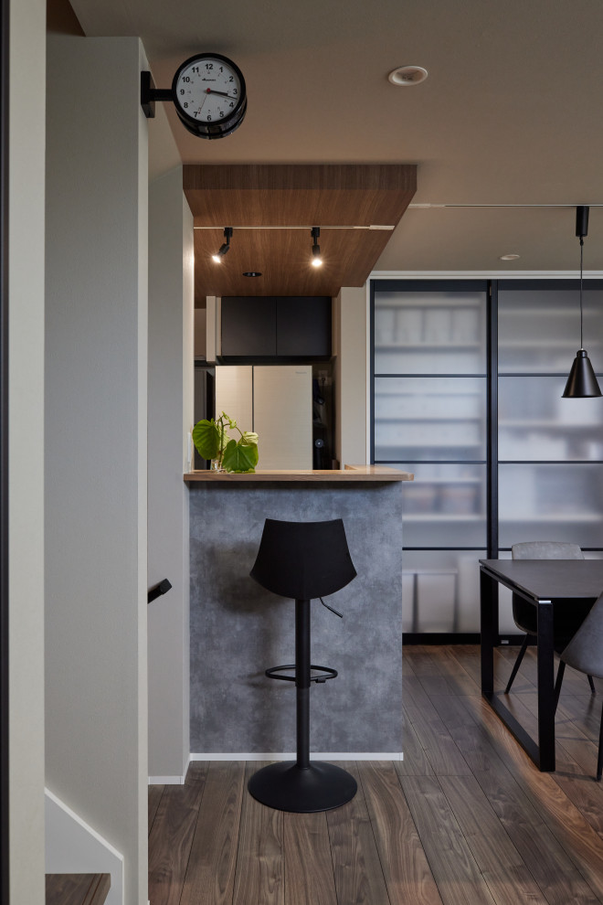 Modern single-wall seated home bar in Other with an undermount sink, flat-panel cabinets, grey cabinets, solid surface benchtops, white splashback, vinyl floors, grey floor and white benchtop.