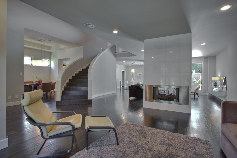 Contemporary living room in Dallas with a two-sided fireplace.