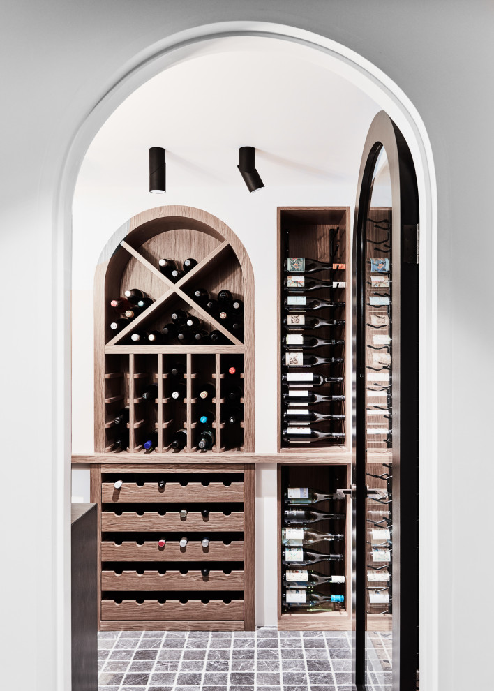 Design ideas for a mid-sized transitional wine cellar in Sydney with marble floors, display racks and grey floor.