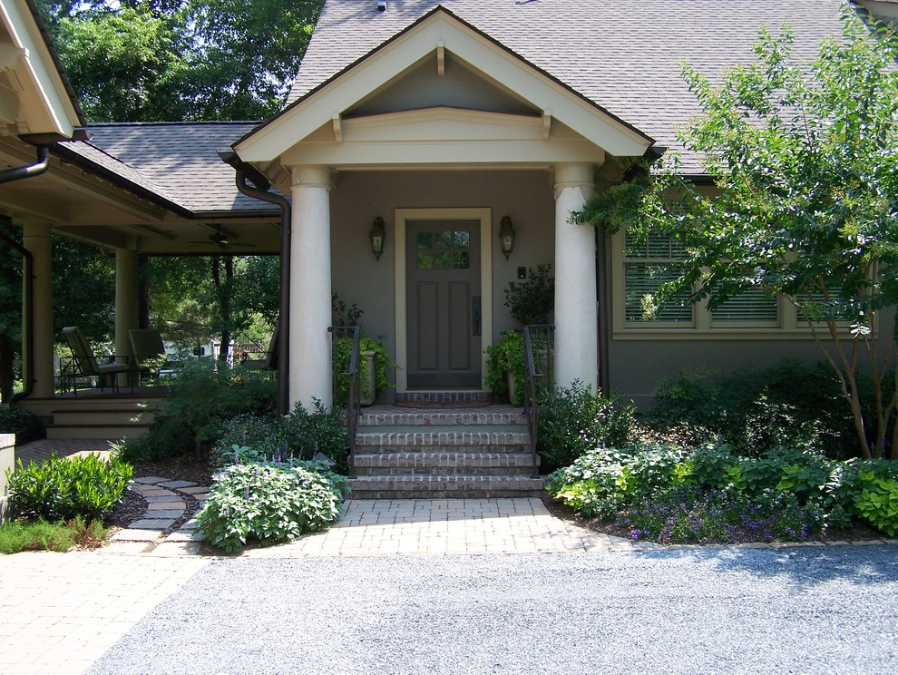 This is an example of a traditional entryway in Raleigh with a single front door and a gray front door.